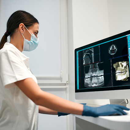 Looking at X-rays of jaw on computer monitor