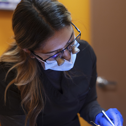 Dental team member wearing glasses with magnification lenses