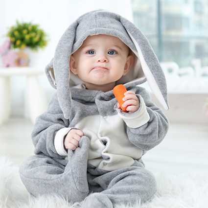 Baby wearing grey rabbit pajamas