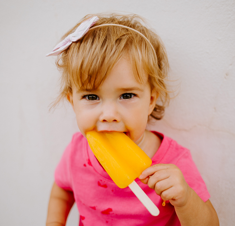 Little girl eating a popsicle