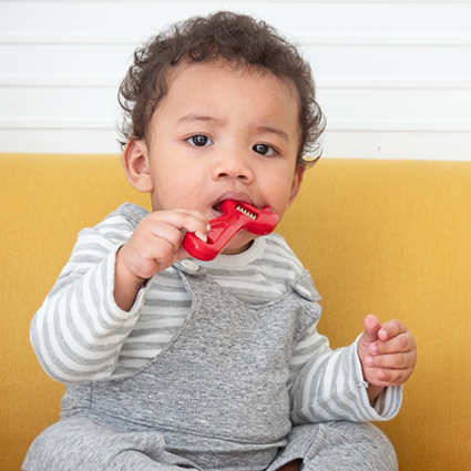 Little boy chewing on a item to help with teething