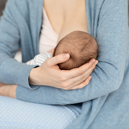 Close up of baby held by mother