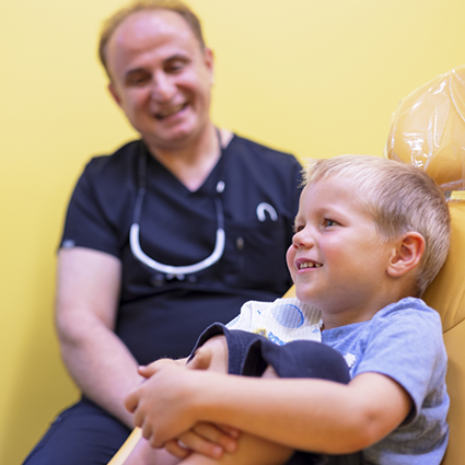 Dr. Dulli and young patient smiling