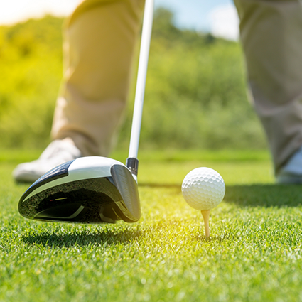 About to hit a golf ball off a tee