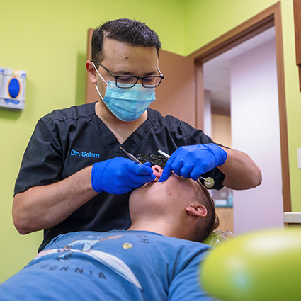 Dr. Salem treating a young patient