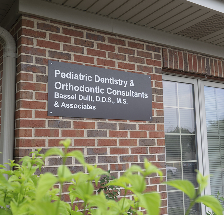 Sign on wall outside of Naperville dental office
