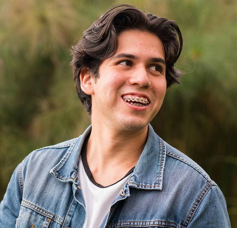 Teenage boy in denim jacket with metal braces