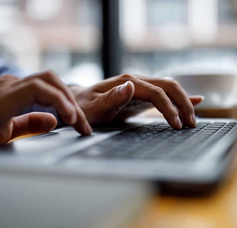 Close up of hands typing on laptop