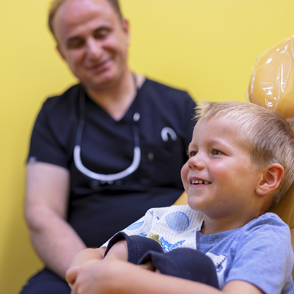 Close up of little boy in dental treatment chair smiling