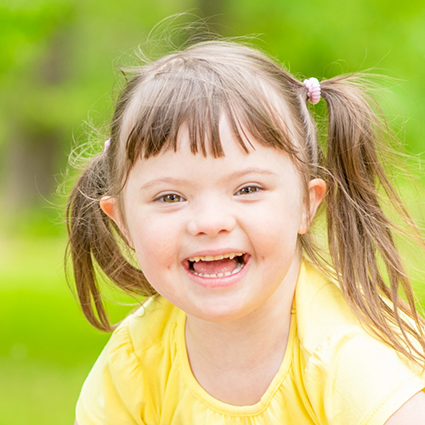 Close up of smiling little girl with pigtails